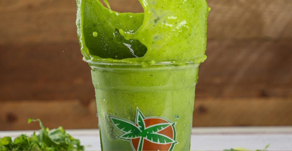Fresh Super Green Juice splashing at Tropical Juice Bar
